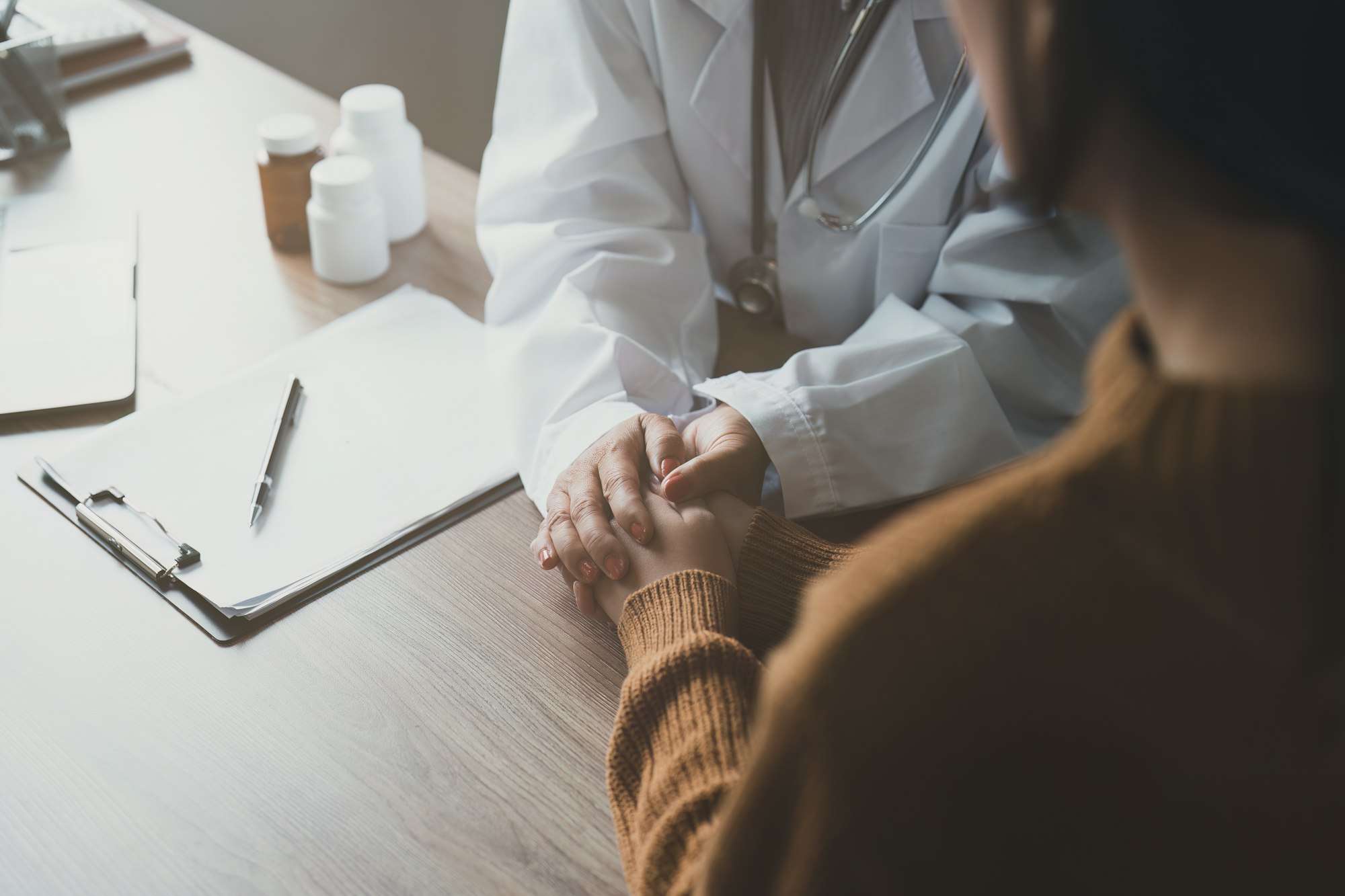 Doctor talking with asian woman. Female primary care physician having conversation with older woman