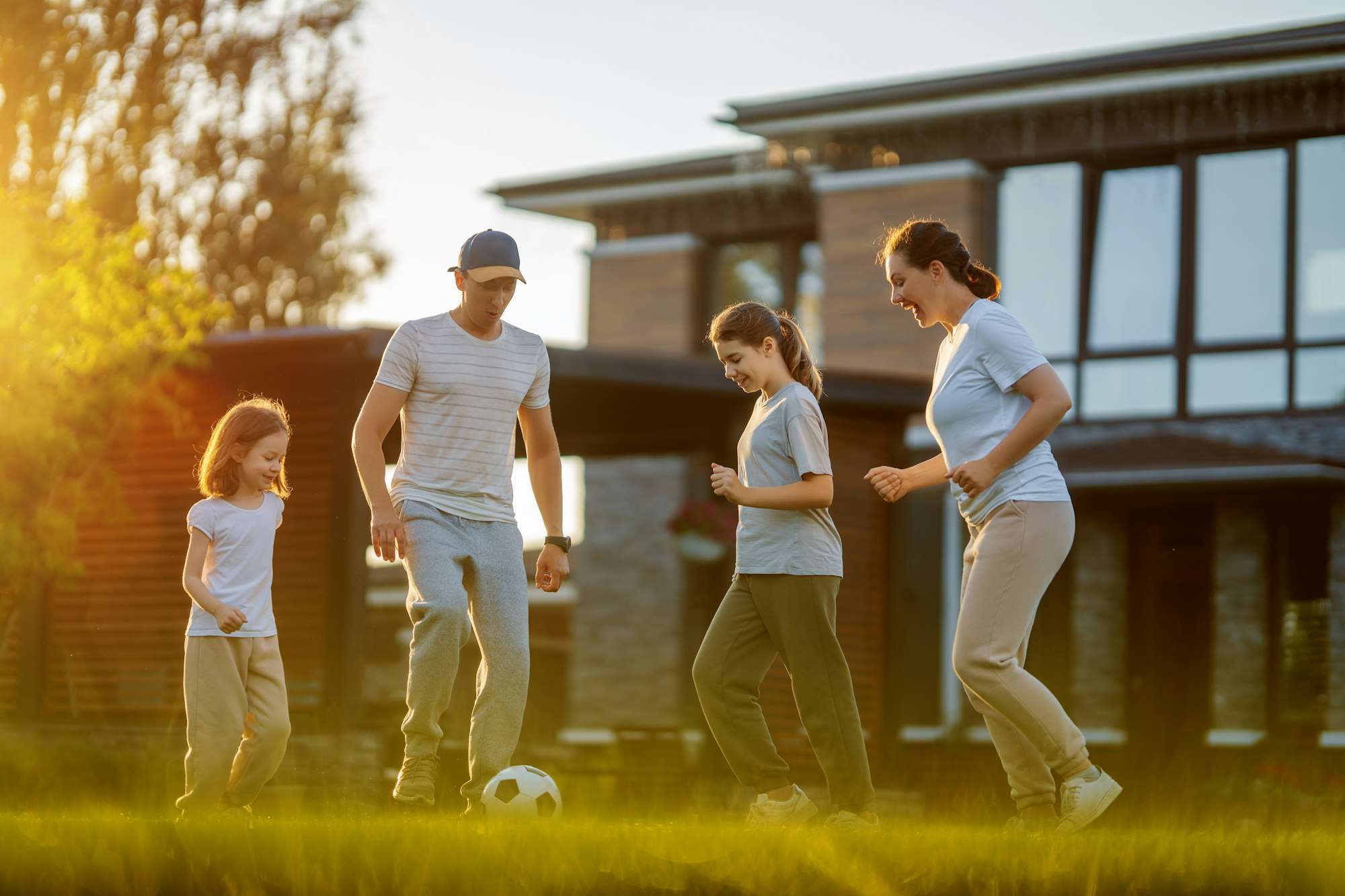 Happy family playing soccer