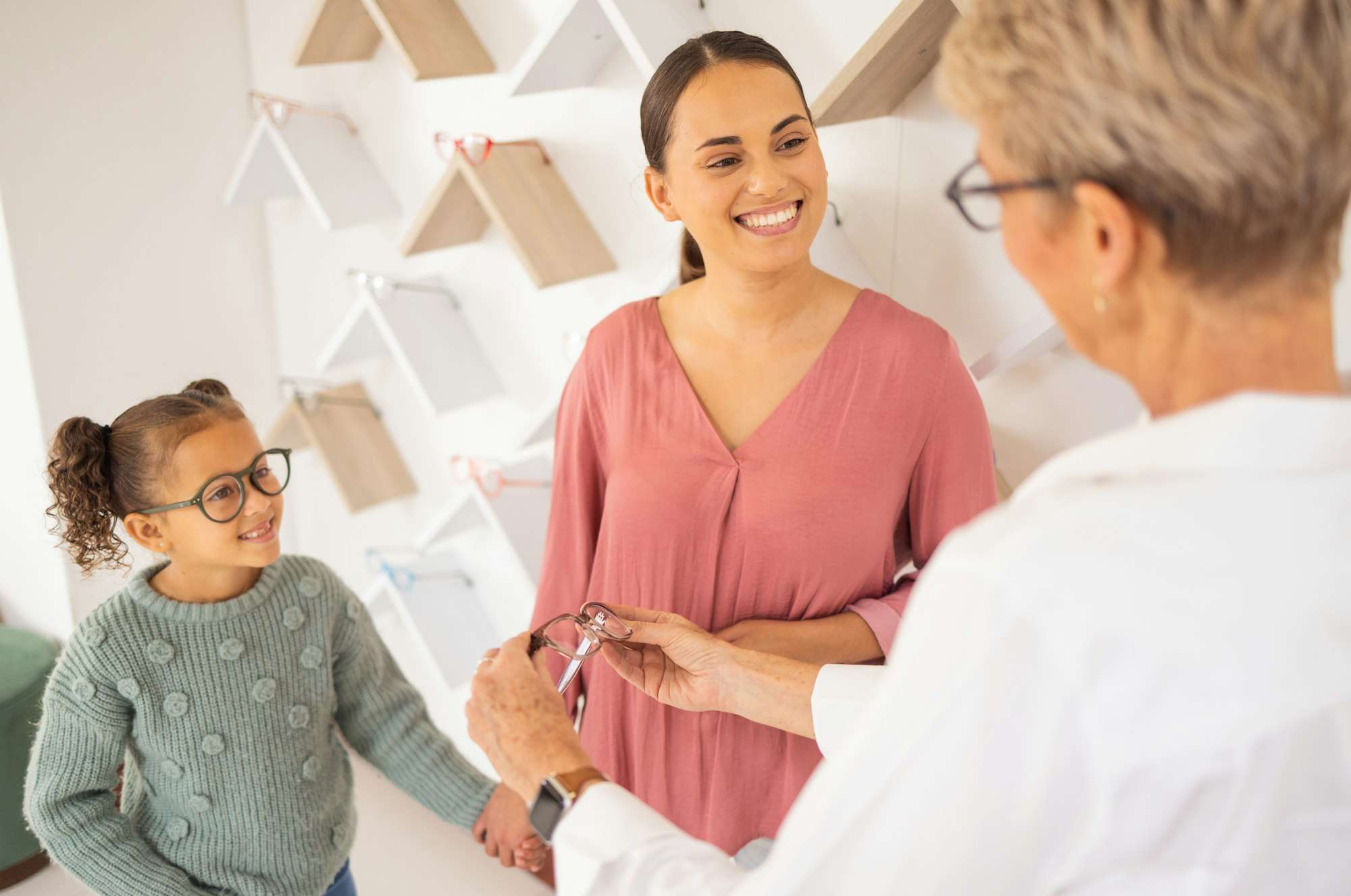 Happy mother, child and and optometrist with glasses eye exam for eyesight, eyes wellness and healt