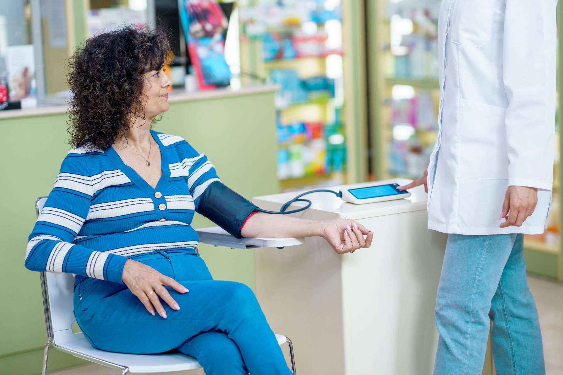Woman getting their blood pressure checked.