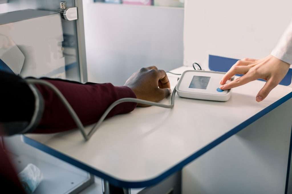 Unrecognizable person getting their blood pressure checked.