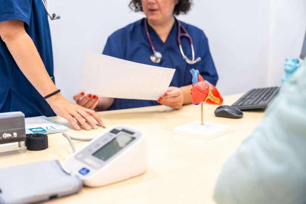 Nurse and doctor sharing paperwork.