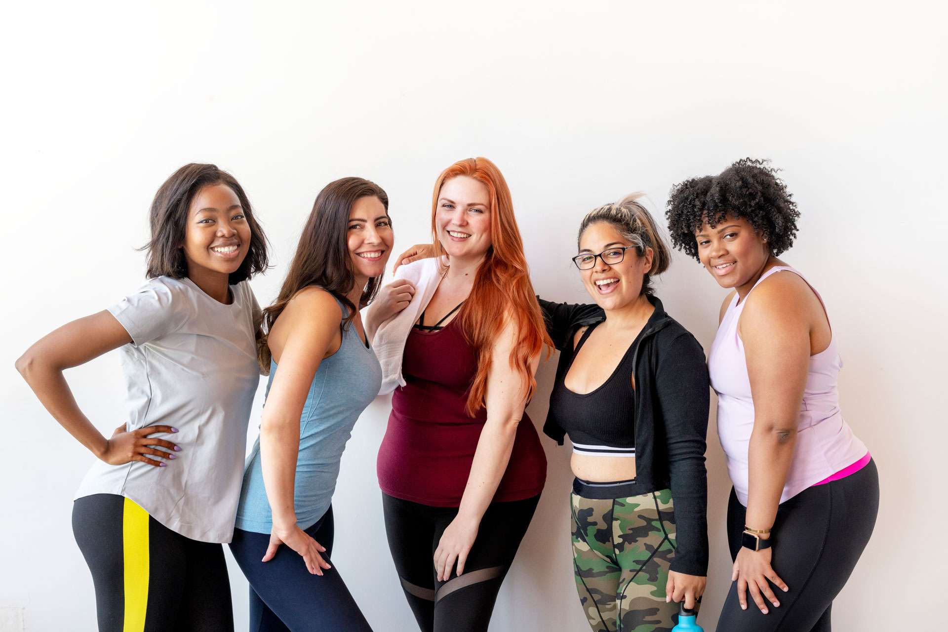 Happy female workout group at the gym.