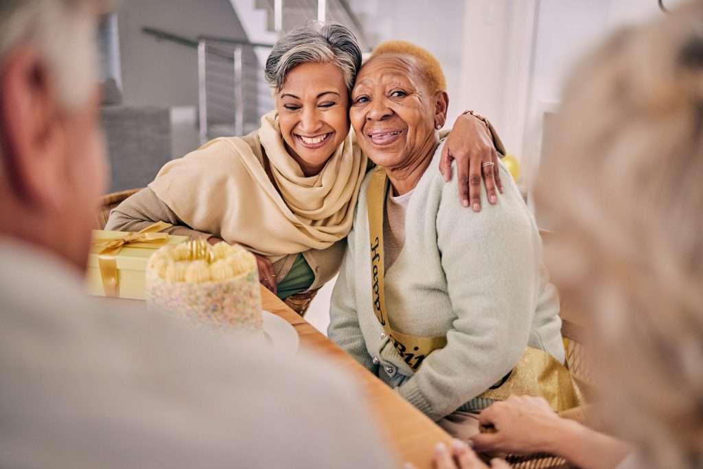 Senior friends hugging each other.