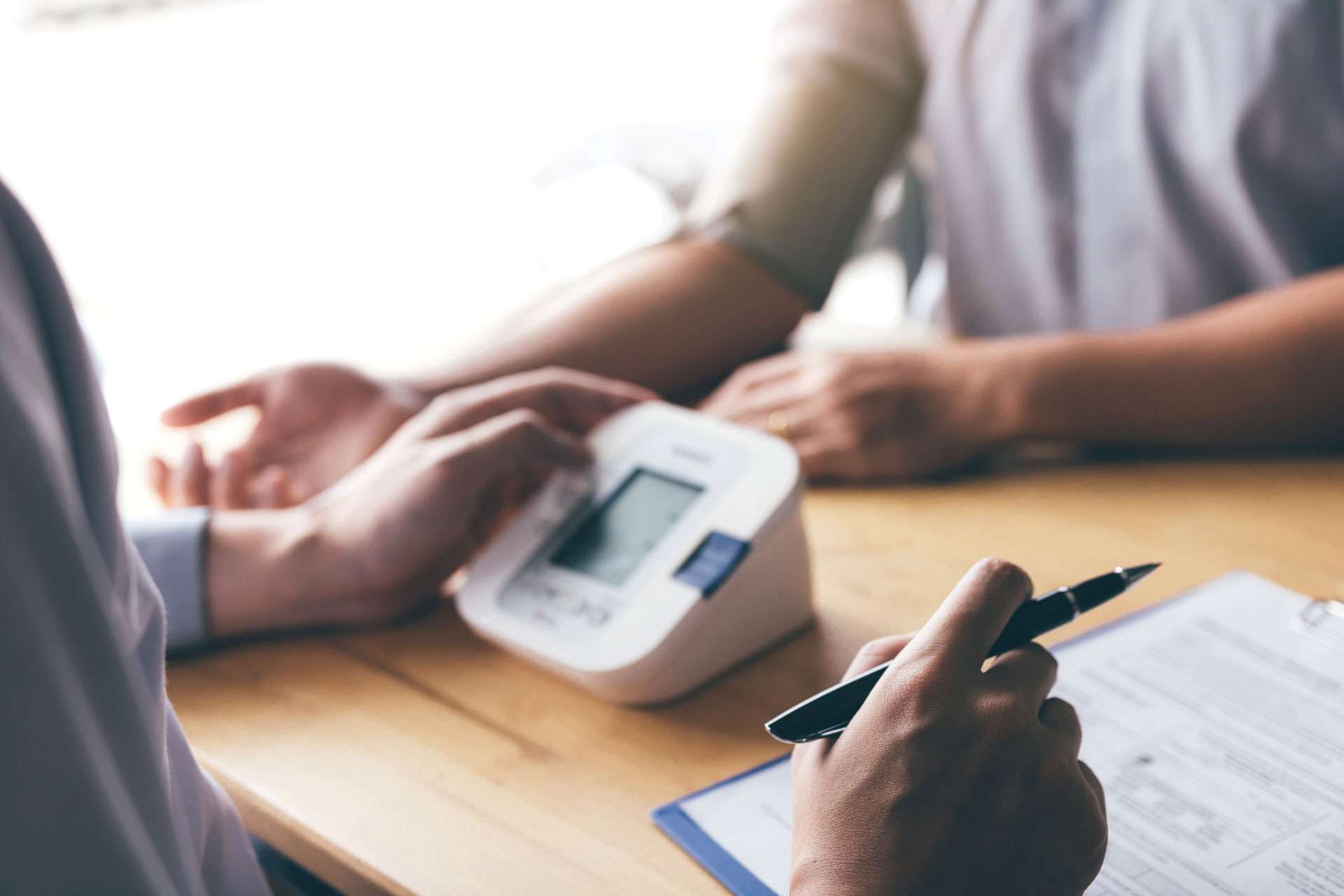 Doctor checking the blood pressure of a patient.