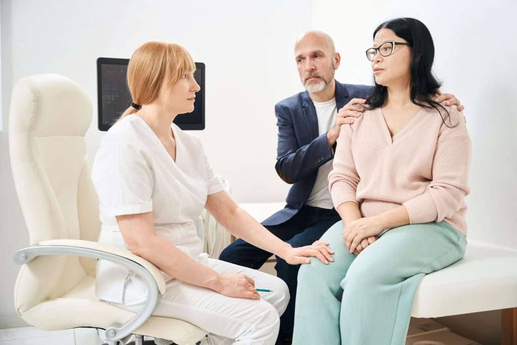 Doctor talking to a couple.