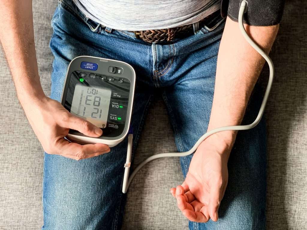 Man checking blood pressure at home.