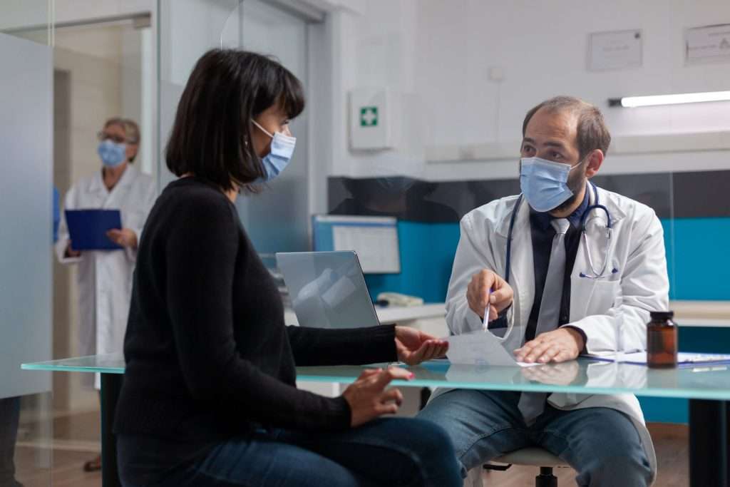 Doctor giving prescription to a patient.