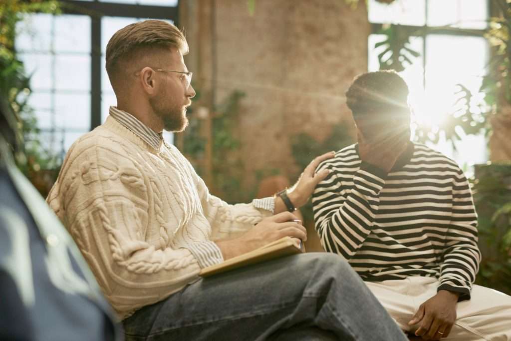 Male psychologist supporting his patient.
