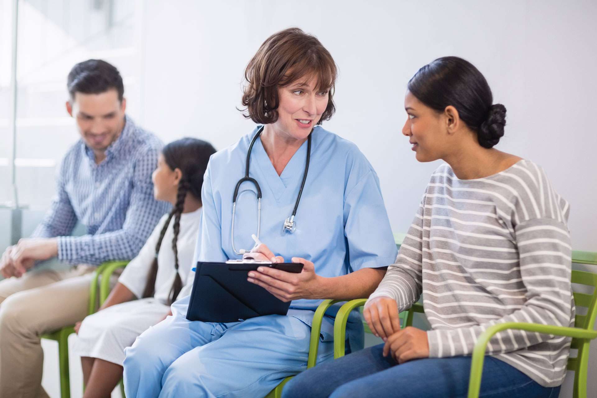 Nurse discussing a medical report to woman.