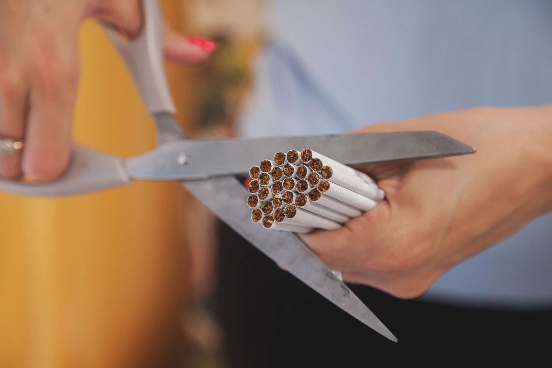 Woman cutting cigarettes.