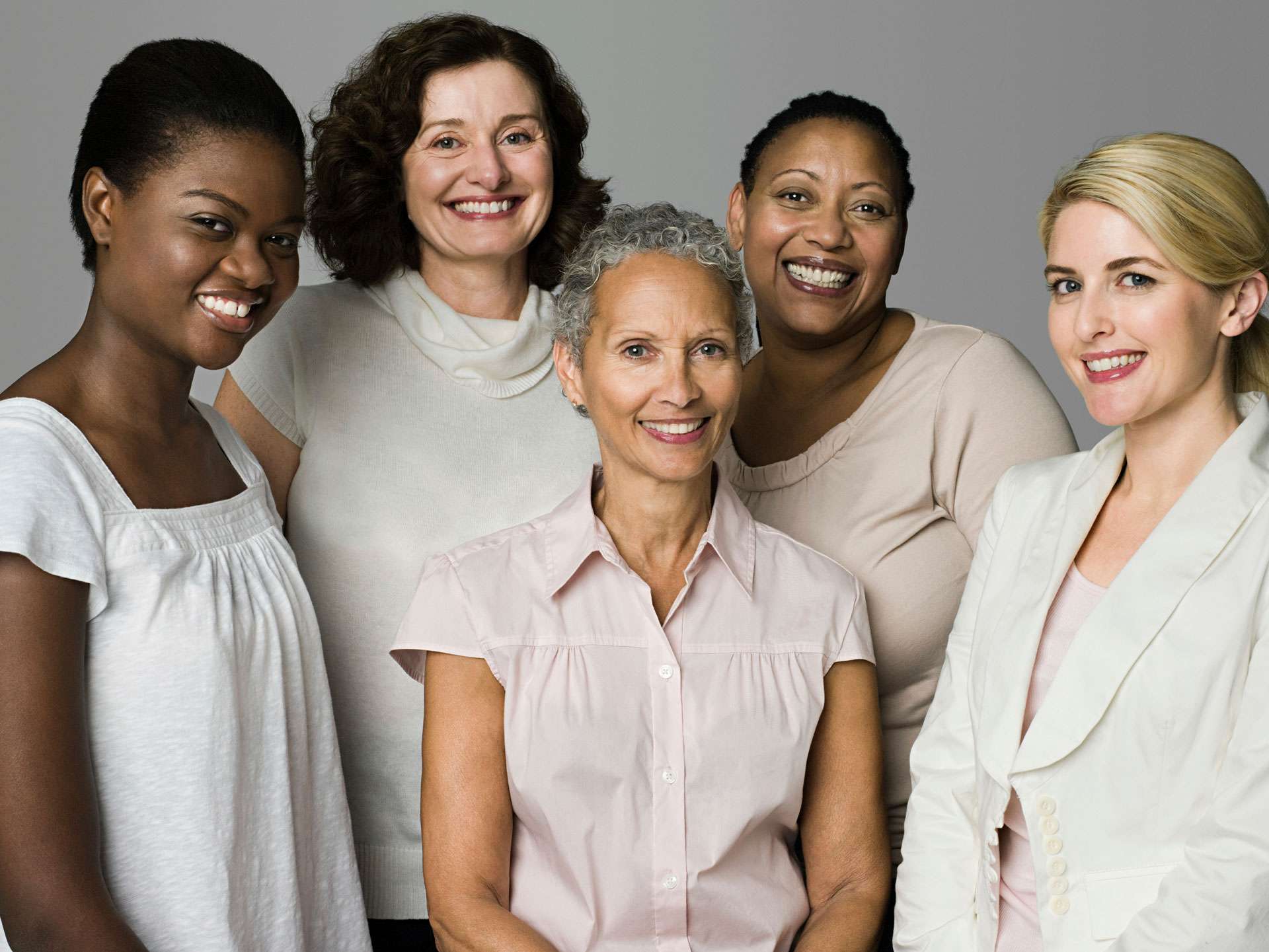 Diverse group of women smiling together.