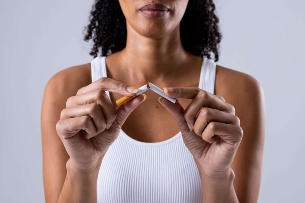 Woman breaking a cigarette.