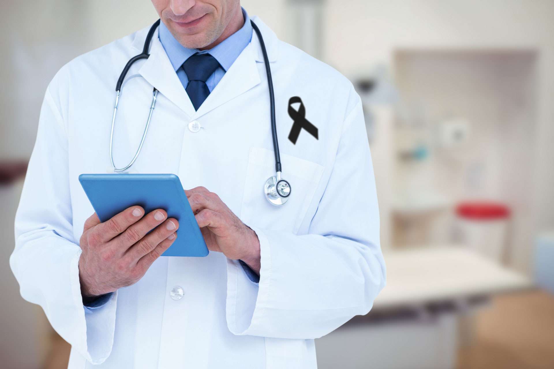 Mid section of a male doctor.