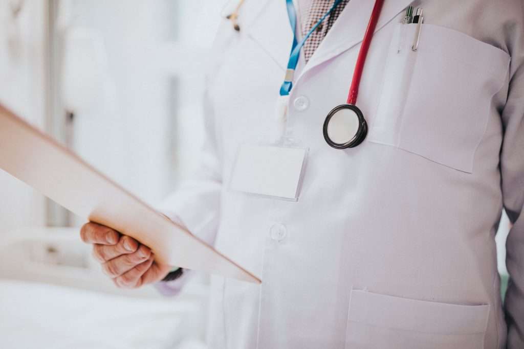 Doctor reading a patient medical record.