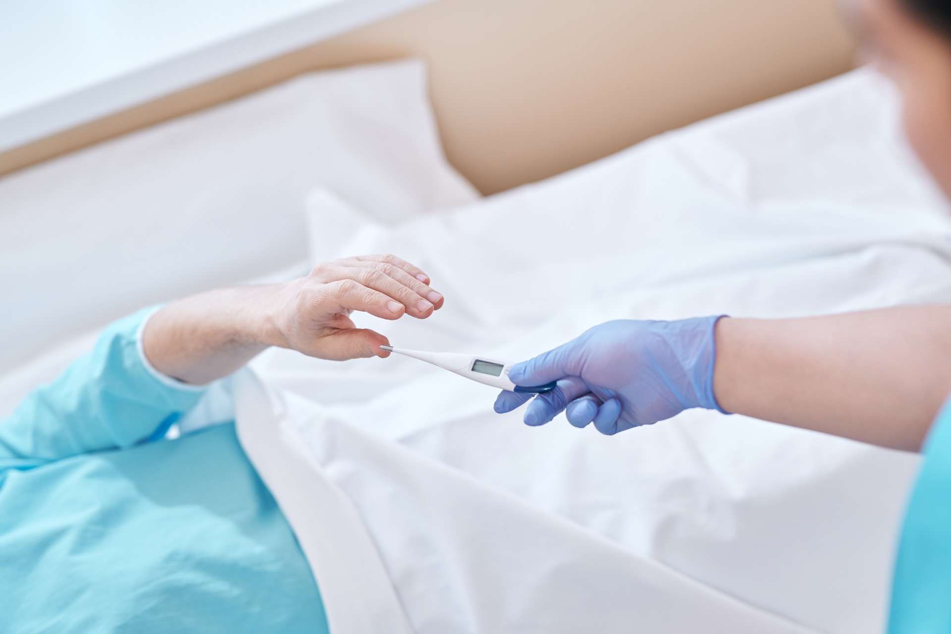 Giving digital thermometer to patient.