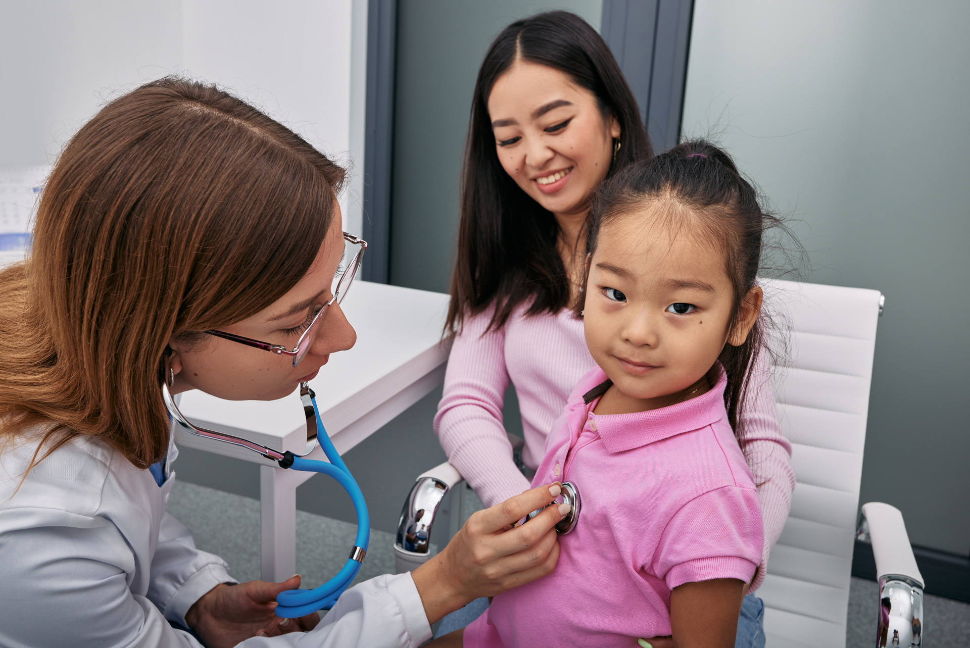Young girl examined by doctor.
