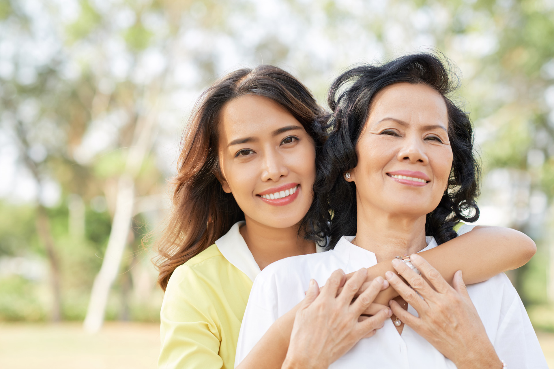 Smiling woman embracing her mother.